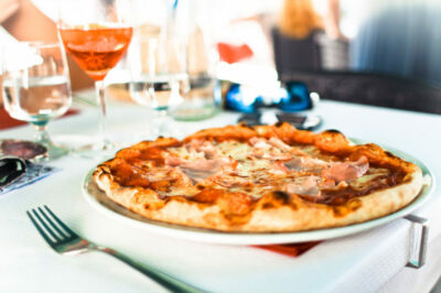 A pizza sitting on top of a pan.