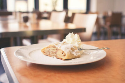 A white plate topped with food on top of a table.