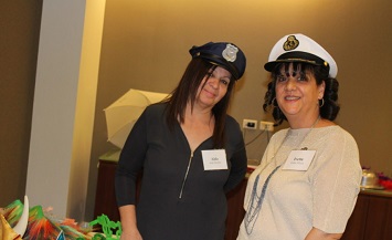 Two women in hats and a black dress