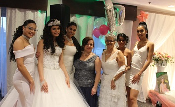 A group of women in wedding dresses posing for the camera.