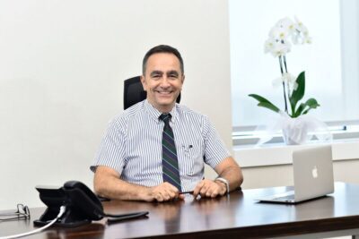 Smiling businessman sitting at desk.