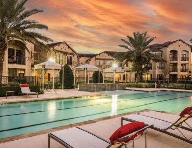 Sunset poolside apartment complex.