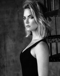 Here's an alt tag for the image: Black and white portrait of Margot Robbie.