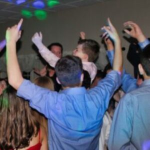 A group of people in the middle of a dance floor.