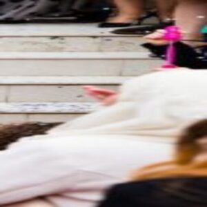 A blurry image of people on steps with one person sleeping.