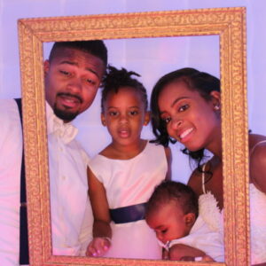 A family is posing for the camera in a picture frame.