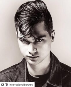 Here's an alt tag for the image: `Man with slicked-back 50s hairstyle`