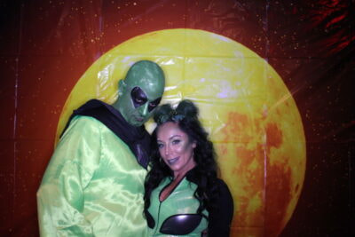 A man and woman dressed as alien and martian.