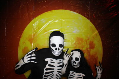 A man and woman dressed as skeletons for halloween.
