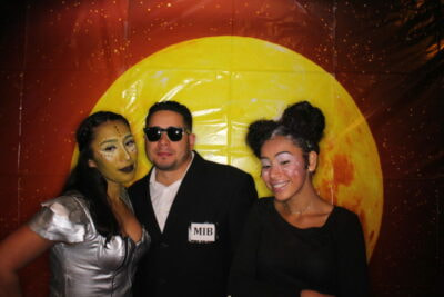 A man and two women posing for the camera.
