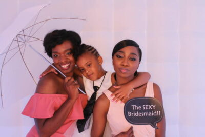 A group of women posing for a photo booth.