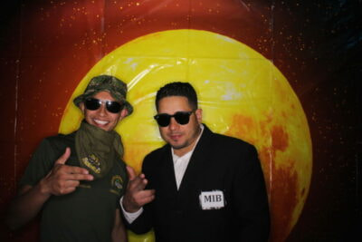 Two men in costumes posing for a picture.