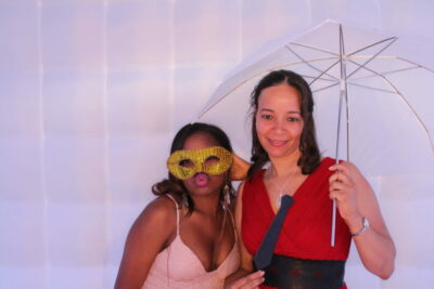 Two women posing for a photo booth picture.