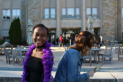 Two women are standing outside of a building.