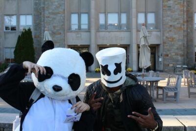Two people wearing panda masks and a marshmello hat.