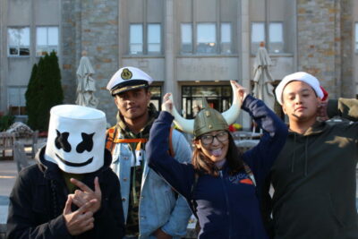 A group of people wearing hats and smiling.