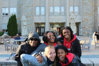 A group of people posing for the camera in front of a building.