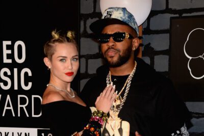 Miley Cyrus and Mike WiLL Made-It at an award show.