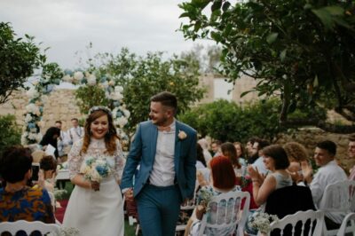 A couple walking down the aisle at their wedding.