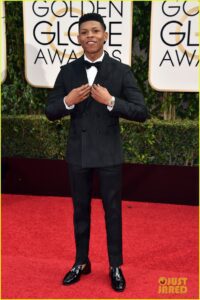 Here's an alt tag for the image: `Caleb McLaughlin at the Golden Globes`